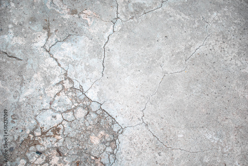 Textura de piso de cemento color gris con desgaste por el tiepo y varias grietas