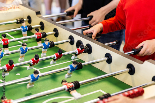 Blurred table football with shiny chrome figures close up