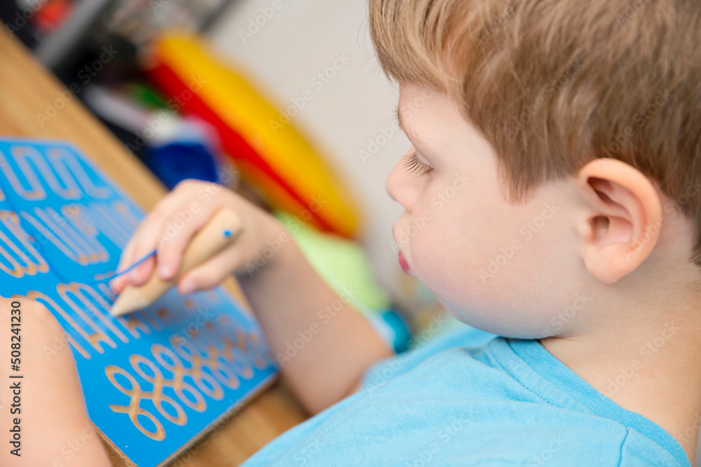 Hand writing training board. Children home activity. Early education, fine motoric skills, learning to write. Primary school exercises. Hand writing training board. Children home activity. Early education, fine motoric skills, learning to write. Primary school exercises.