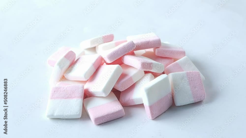 slow motion of marshmallow candy dropping on white slow motion of marshmallow candy dropping on white