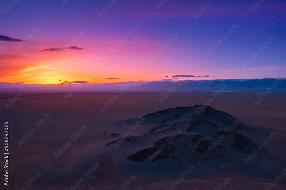 Beautiful panoramic aerial view landscape of snow mountain Altai sunset above clouds