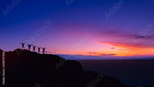 Back view five friends tourists are looking on mountains and having fun together sunset Altai. Concept banner travel holiday