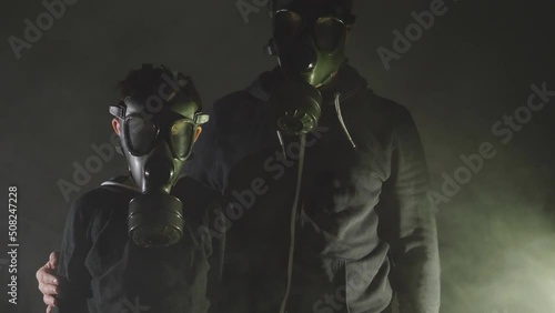 Man and child wearing gas mask, survivors, dark life, pollution protection