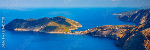 Assos village in Kefalonia, Greece. Turquoise colored bay in Mediterranean sea with beautiful colorful houses in Assos village in Kefalonia, Greece, Ionian island, Cephalonia, Assos village.