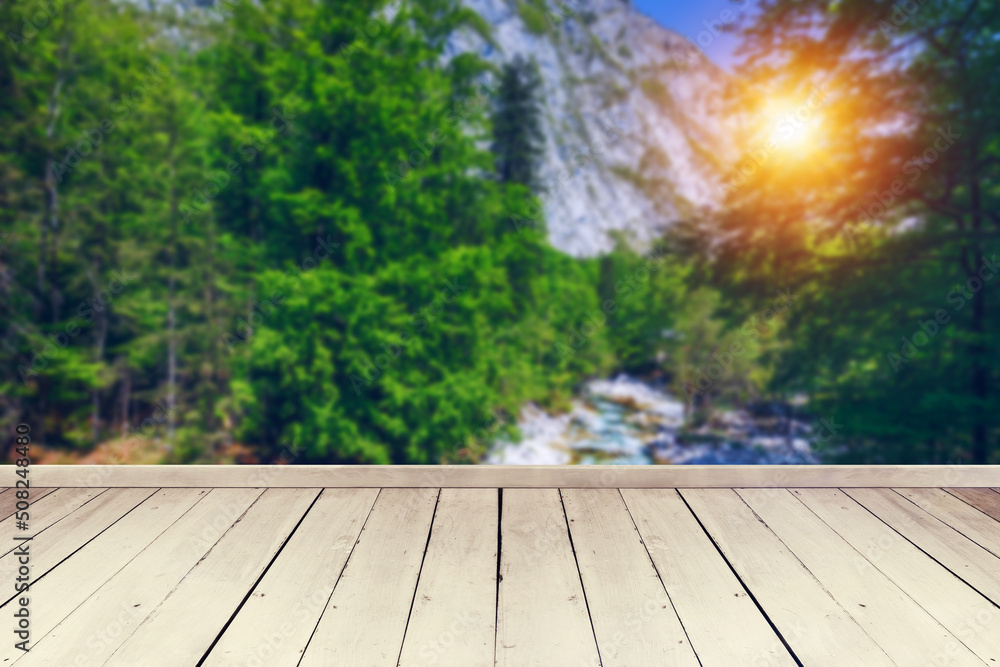 Empty wooden table in front of abstract blurred background in nature, can be used for display or montage your products. Mock up for display of product
