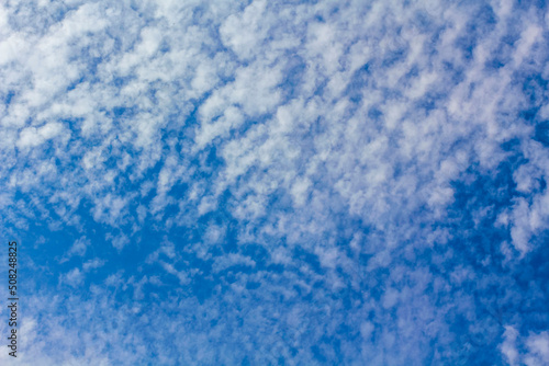 Blue sky with chemical clouds chemtrails on sunny day Germany. photo