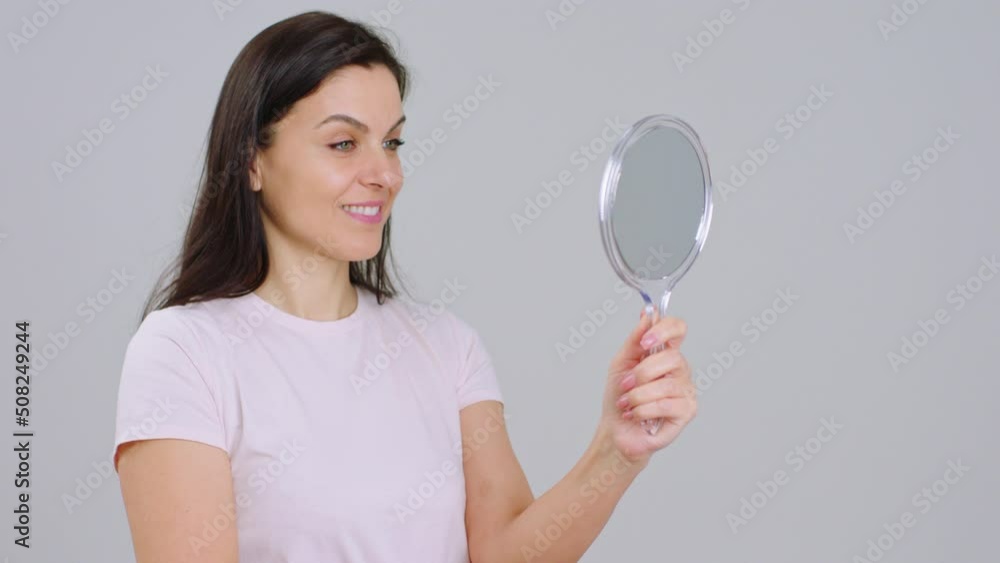 Concept of healthy skin treatment skincare on white background adult woman very beautiful with a good skin looking through the mirror and smiling large Concept of healthy skin treatment skincare on white background adult woman very beautiful with a good skin looking through the mirror and smiling large