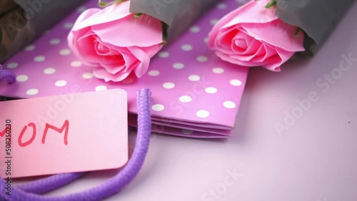 mother dayconcept with pink color rose flower and mom text on paper  photo