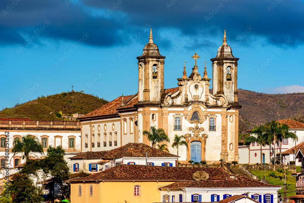 Old churches on top of the hill and between the houses in the city of Ouro Preto in Minas Gerais during the late afternoon