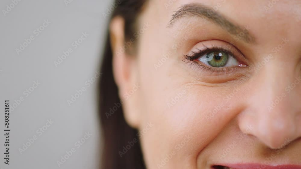 Video details closeup to the camera adult woman smiling and looking straight to the camera with her amazing green eyes and perfect skin Video details closeup to the camera adult woman smiling and looking straight to the camera with her amazing green eyes and perfect skin