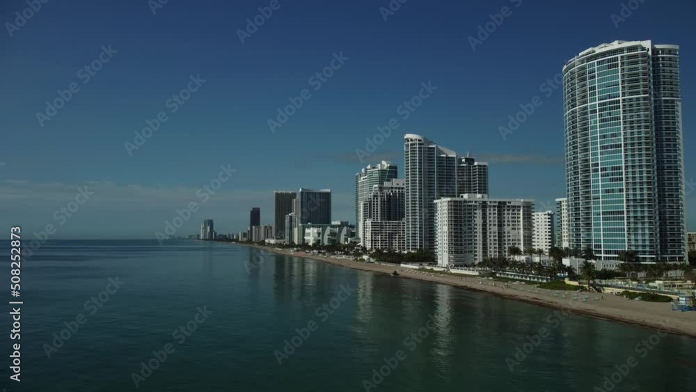 Aerial view of condos, apartment buildings and hotels with ocean views. The water is flat, calm on this tranquil day showing off this excellent South Florida tourist destination. Aerial view of condos, apartment buildings and hotels with ocean views. The water is flat, calm on this tranquil day showing off this excellent South Florida tourist destination.