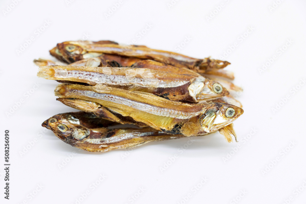 Dried Small fish or Salted anchovy fishes over on white background, selective focus Dried Small fish or Salted anchovy fishes over on white background, selective focus