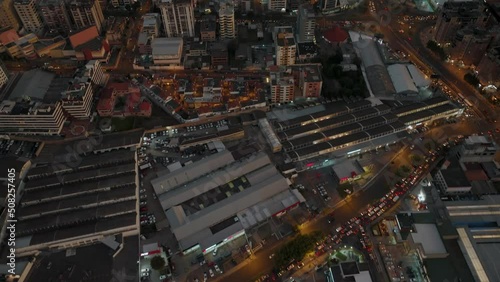 Heavy Traffic In Quito City On A Cloudy Night With High-rise And Residential Buildings In Ecuador. - aerial tilt up