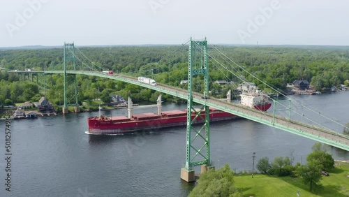 Tanker Ship Passes Under the Thousand Islands Bridge in Alexandria Bay, New York - Aerial Drone View in HD and 4K photo