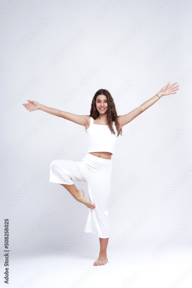Young beautiful girl doing yoga poses, studio white background