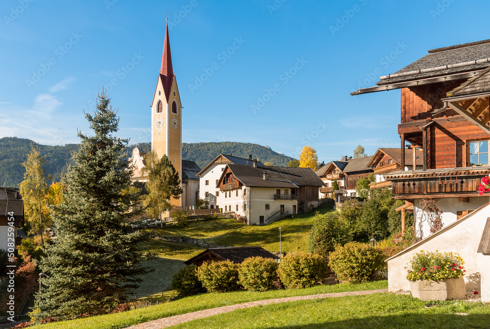 View of the Monguelfo-Tesido village with the bell tower of the Parish Church of Saints Ingenuino and Albuino, province of Bolzano, South Tyrol, Italy