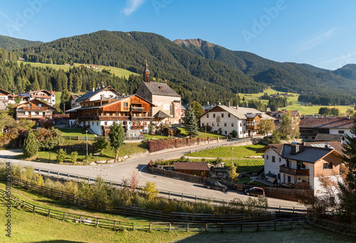 View of the Monguelfo-Tesido village with ancient church of Saint Giorgio, province of Bolzano, South Tyrol, Italy photo