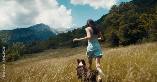 Wallpaper Mural Excited carefree young adult woman run with bordercollie dog on mountain meadow. Inspired happy girl hike with domestic animal on summer vacation. Female traveler on lifestyle journey wanderlust Torontodigital.ca