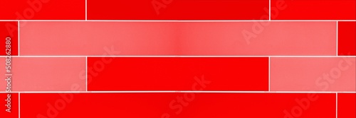 Red panoramic background. Facade of a modern building covered with red plates