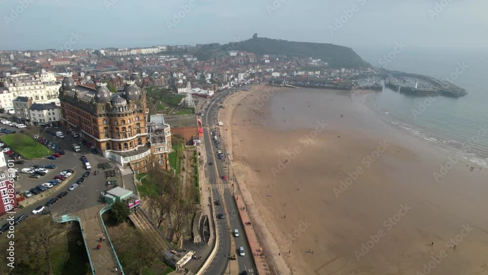 Foreshore road at Scarborough with Grand Hotel and port in background, Yorkshire in England. Aerial descending