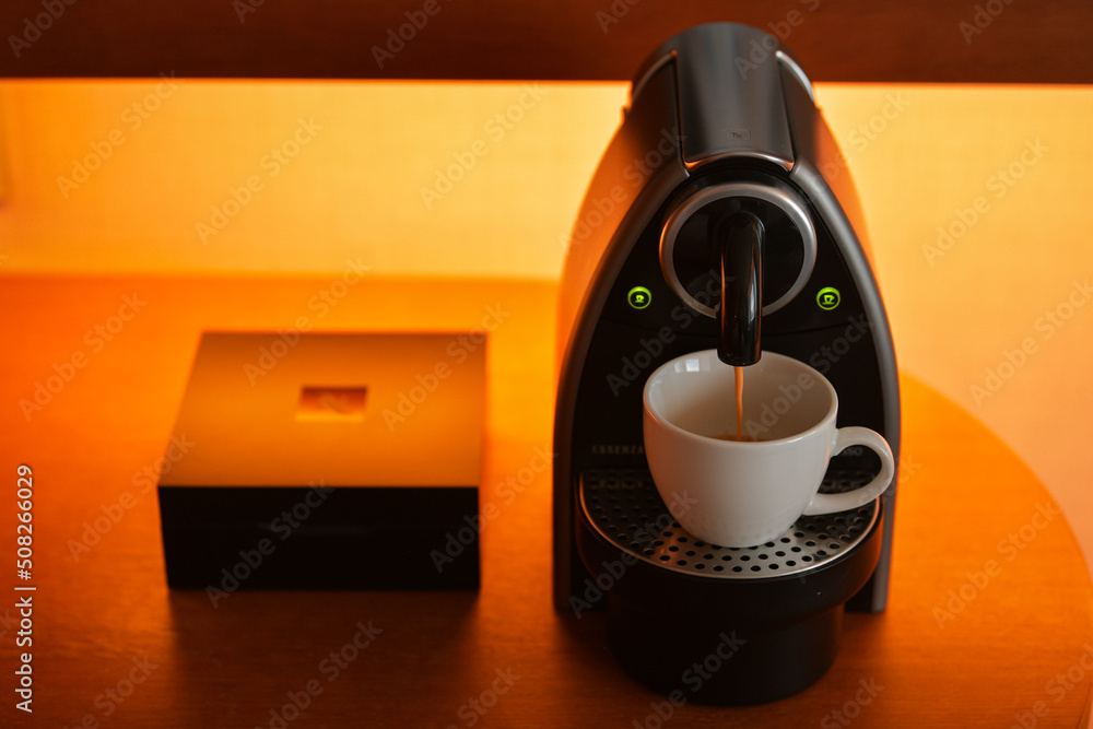 Nespresso Essenza coffee machine preparing an espresso coffee on a