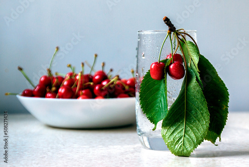 red cherries in white bowl