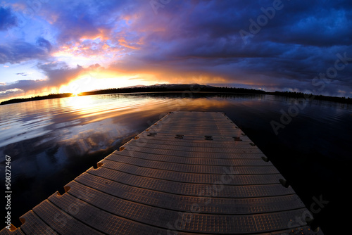 Lake at Sunset or Sunrise with Dock Floating in Water