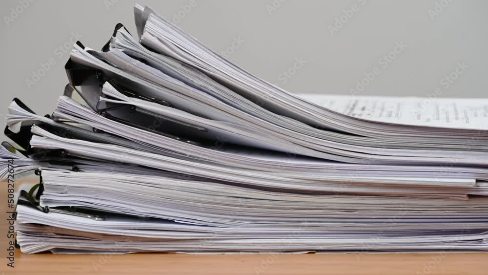 Businessman are searching for documents lying on the table, business report papers, important documents. Businessman are searching for documents lying on the table, business report papers, important documents.