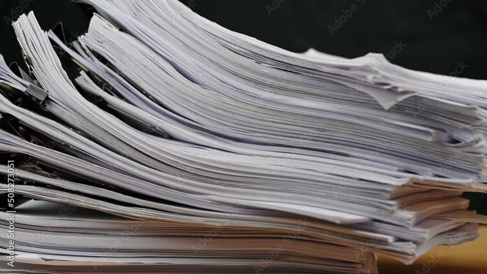 Businessman are searching for documents lying on the table, business report papers, important documents. Businessman are searching for documents lying on the table, business report papers, important documents.