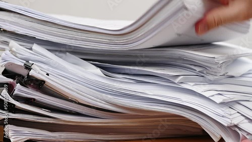 Businessman are searching for documents lying on the table, business report papers, important documents.