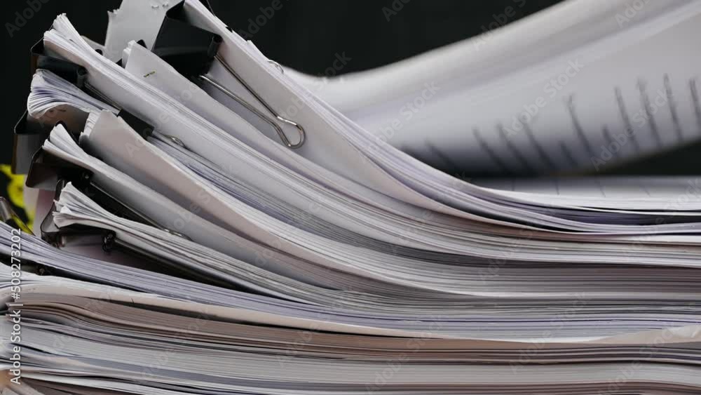 Businessman are searching for documents lying on the table, business report papers, important documents. Businessman are searching for documents lying on the table, business report papers, important documents.