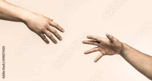 Two hands, helping arm of a friend, teamwork. Helping hand concept and international day of peace, support. Closeup. Helping hand outstretched, isolated arm, salvation. Close up help hand