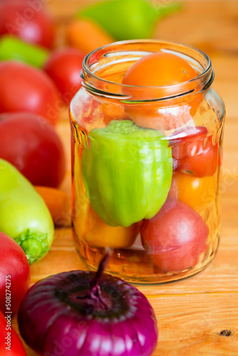 Vegetables prepared for preservation in a glass jar selective focus close-up