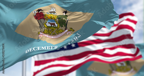 Photos Delaware state flags waving along with the national flag of the United States of