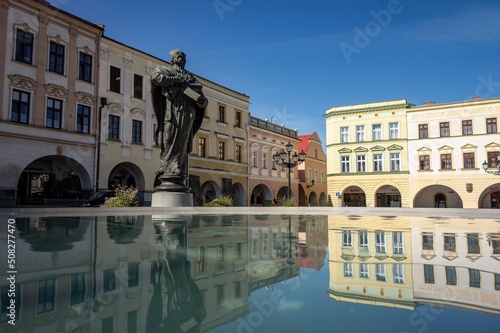 Socha svateho Mikulase statue at Masarykovo namesti town square in Novy Jicin, Czechia mirrored in a circle pool photo