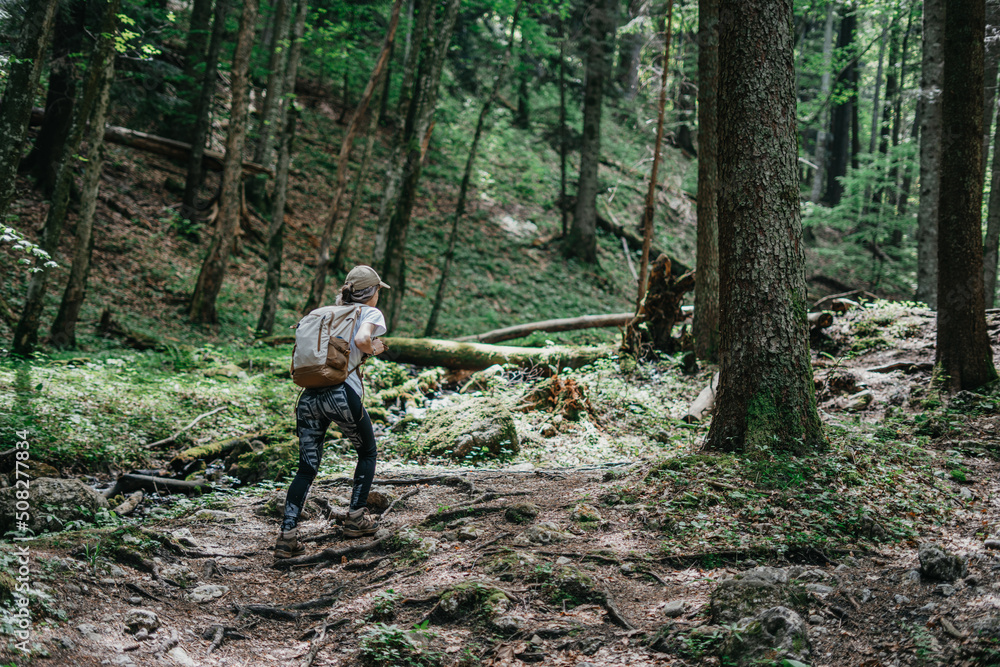 Young sporty girl with leggings carrying a backpack in the forest Young sporty girl with leggings carrying a backpack in the forest