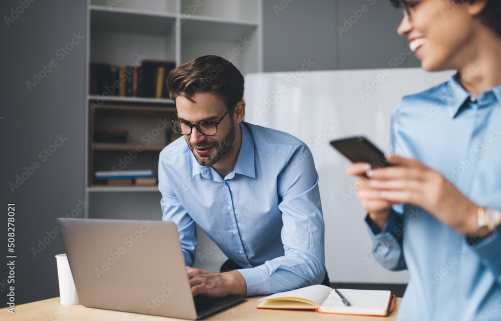 Millenial business man and woman working in office Millenial business man and woman working in office