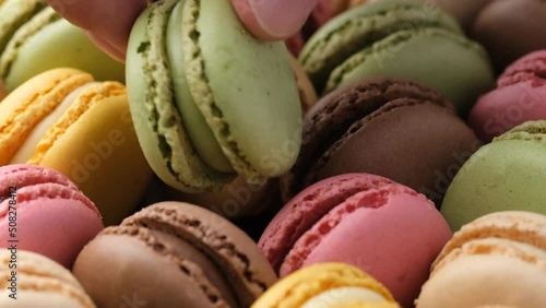 Taking from box macarons French sandwich cookie