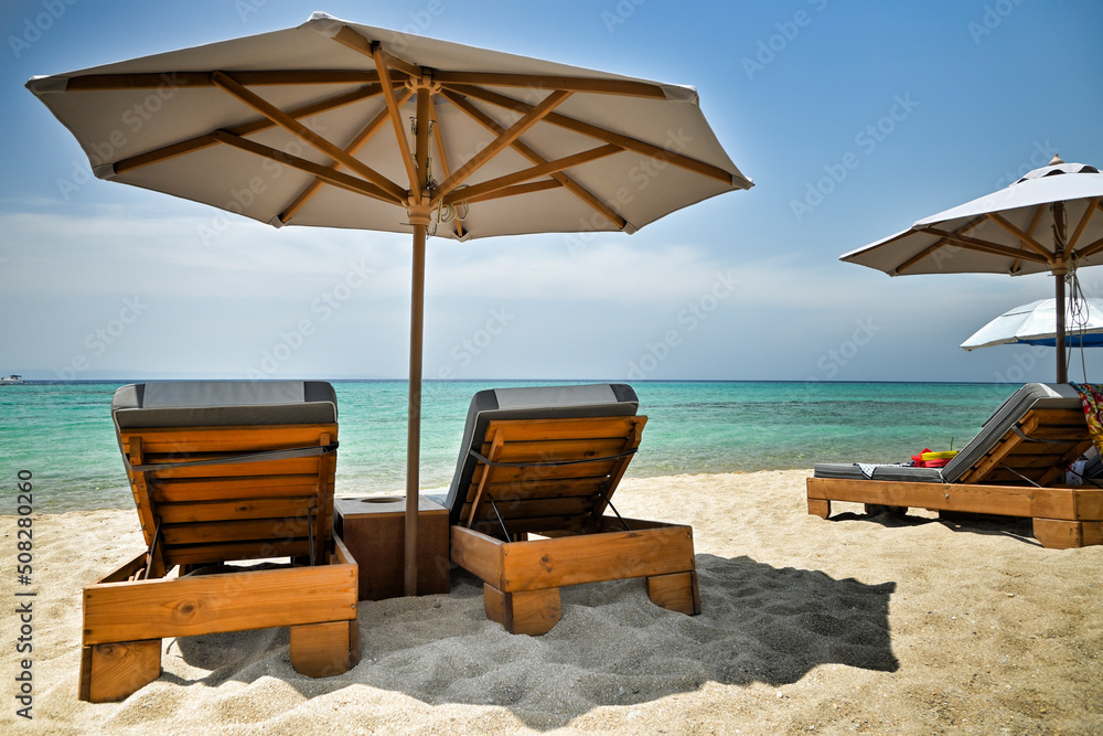 luxurious sunbeds and umbrella on beautiful beach