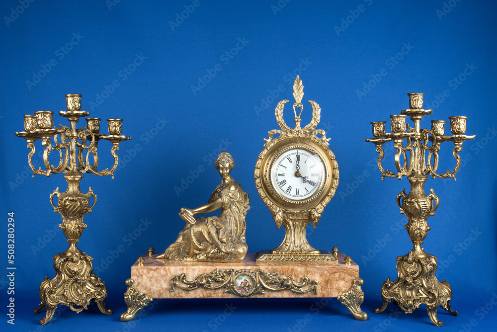 Antique table clock and two candlesticks. Vintage bronce watch with