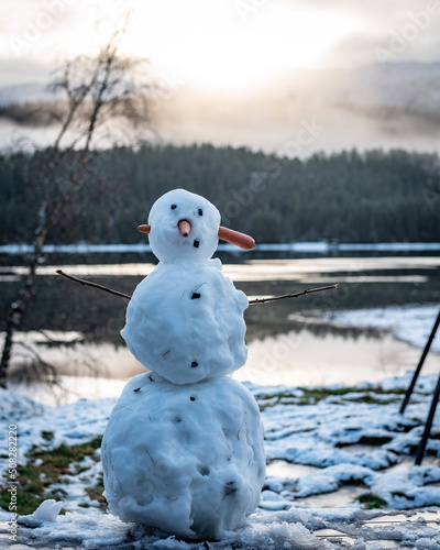 Ugly snowman by the lake