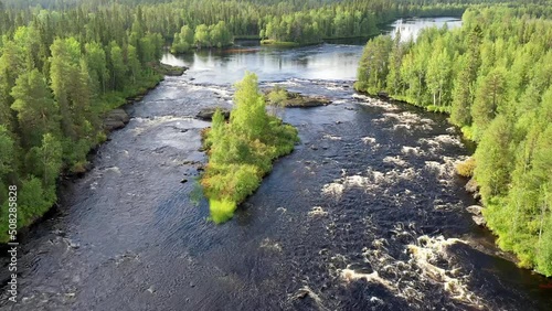 Push in aerial shot of Koshmariki rapid on Tuntsayoky river on sunny summer day. Murmansk Oblast, Russia.