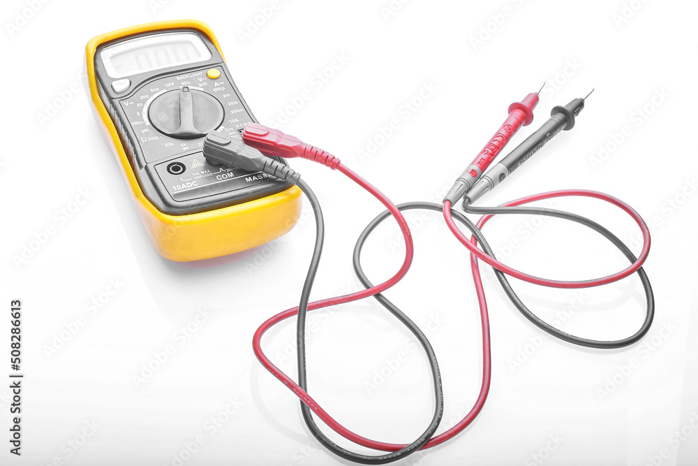 multimeter with wires for measuring on a white background multimeter with wires for measuring on a white background