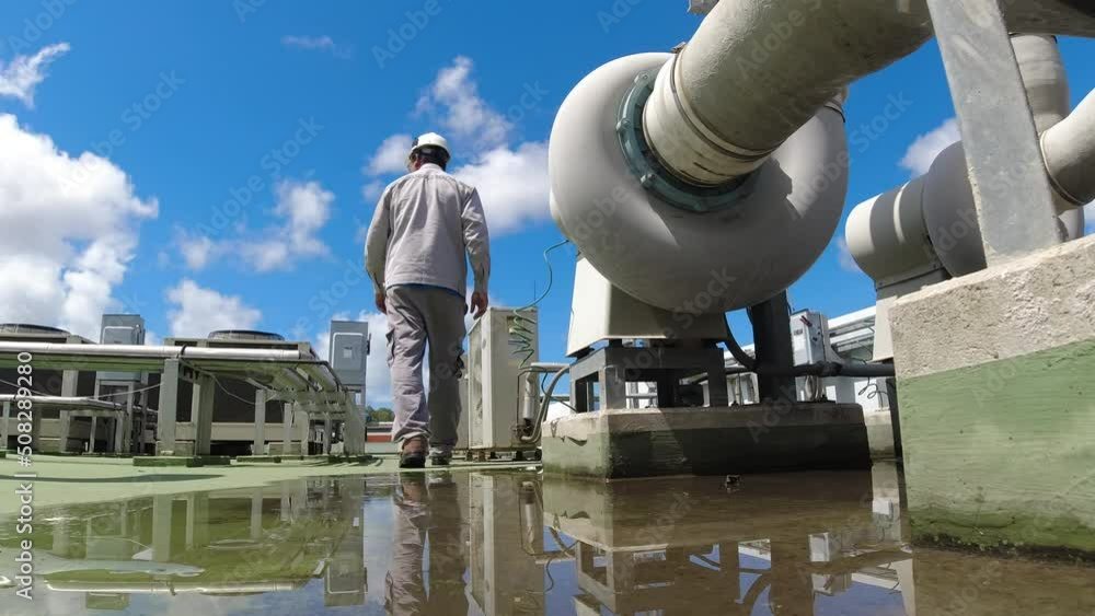 Engineer in a hard hat and safety uniform. The air conditioning system