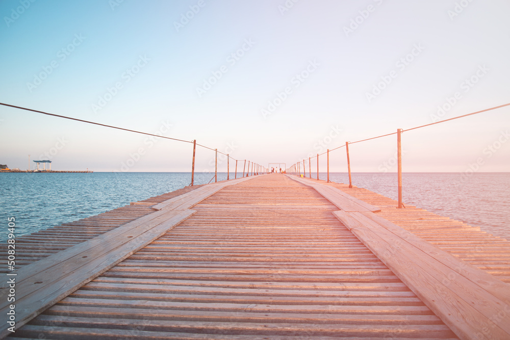 Obraz premium Wooden pier near the blue sea.