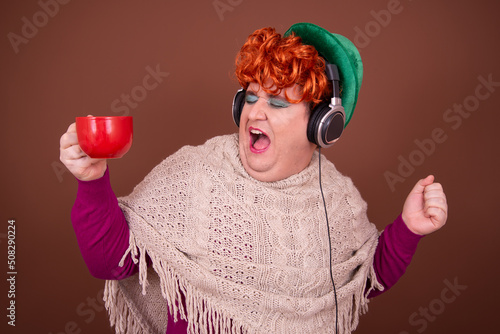 Canvas Print Drag Queen listens to music on headphones and drinks coffee.