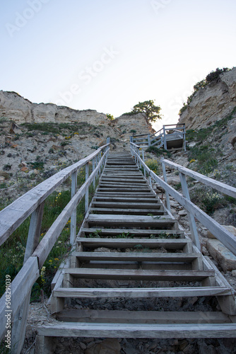 Wooden staircase leading from the mountains to the sea. Paradise place for tourism and recreation. Hiking.