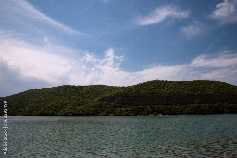 Forest mountains and a large lake. Natural landscape summer.
