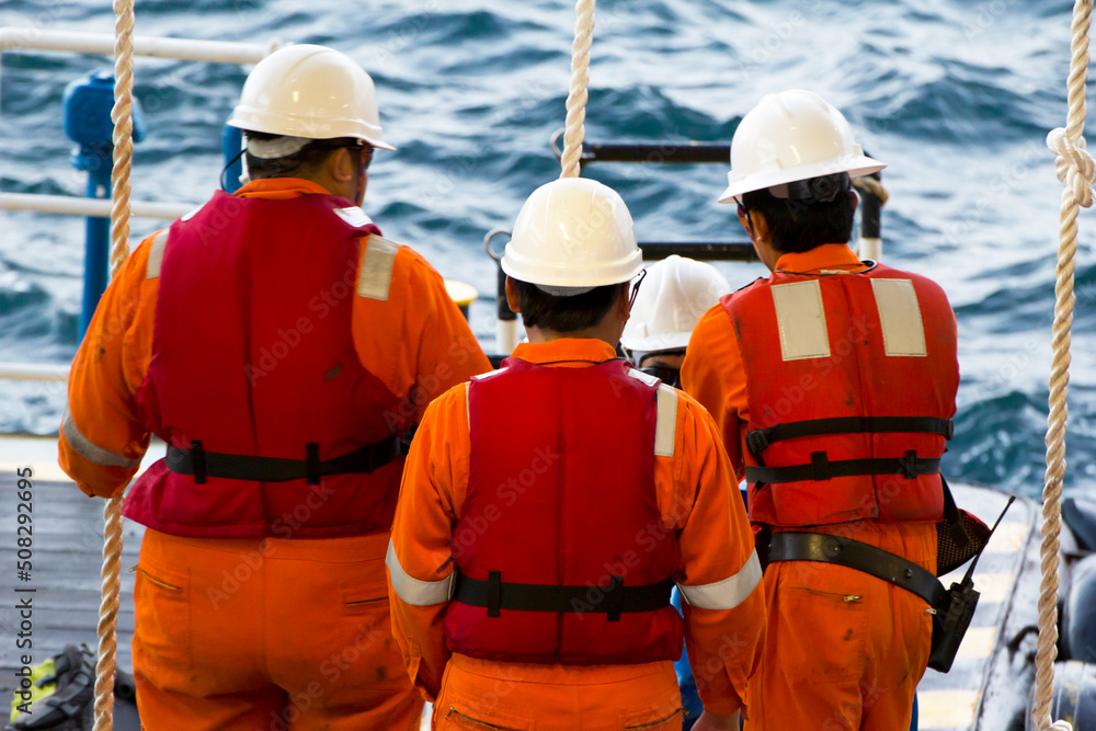 Rig workers are transported on a vessel to offshore rigs in The South China Sea, Brunei. A swing rope is used to enter the platform Rig workers are transported on a vessel to offshore rigs in The South China Sea, Brunei. A swing rope is used to enter the platform