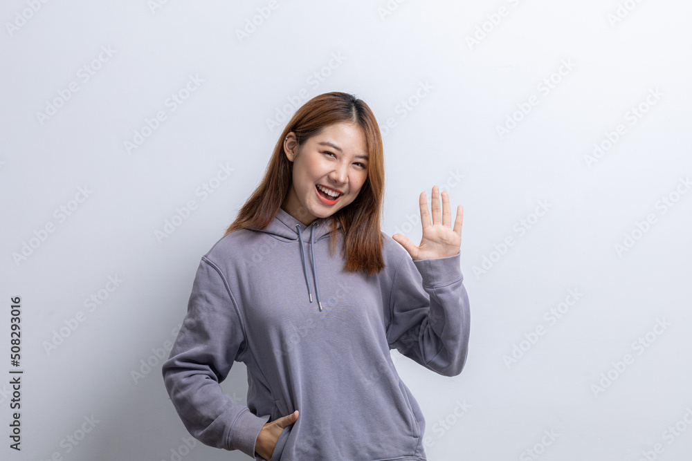 Portrait of beautiful Asian woman doing cheerful pose on isolated background, portrait concept used for advertisement and signage, isolated over white background, copy space. Portrait of beautiful Asian woman doing cheerful pose on isolated background, portrait concept used for advertisement and signage, isolated over white background, copy space.